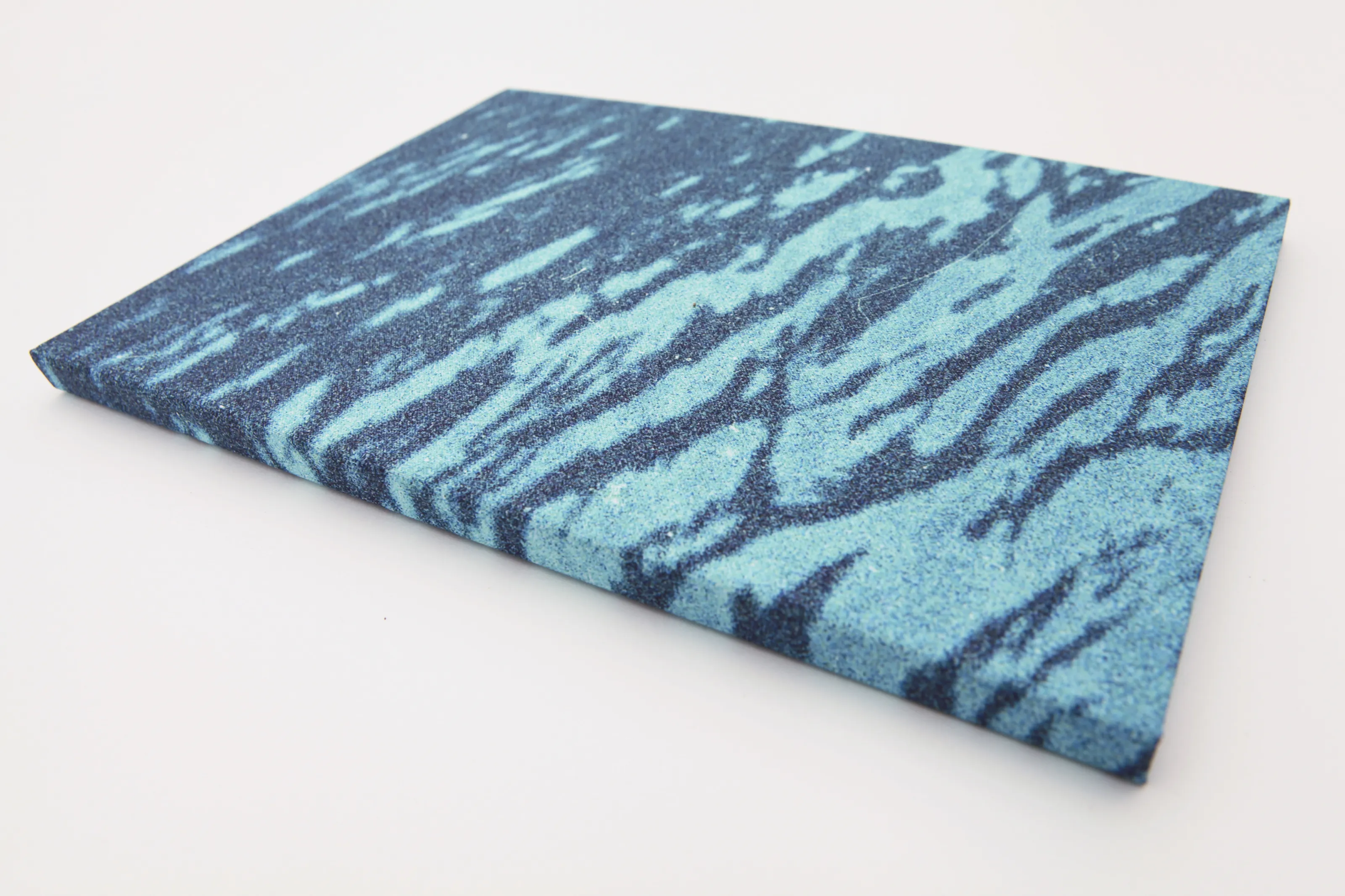 Linen-bound book with a close-up of a water surface printed on the cover