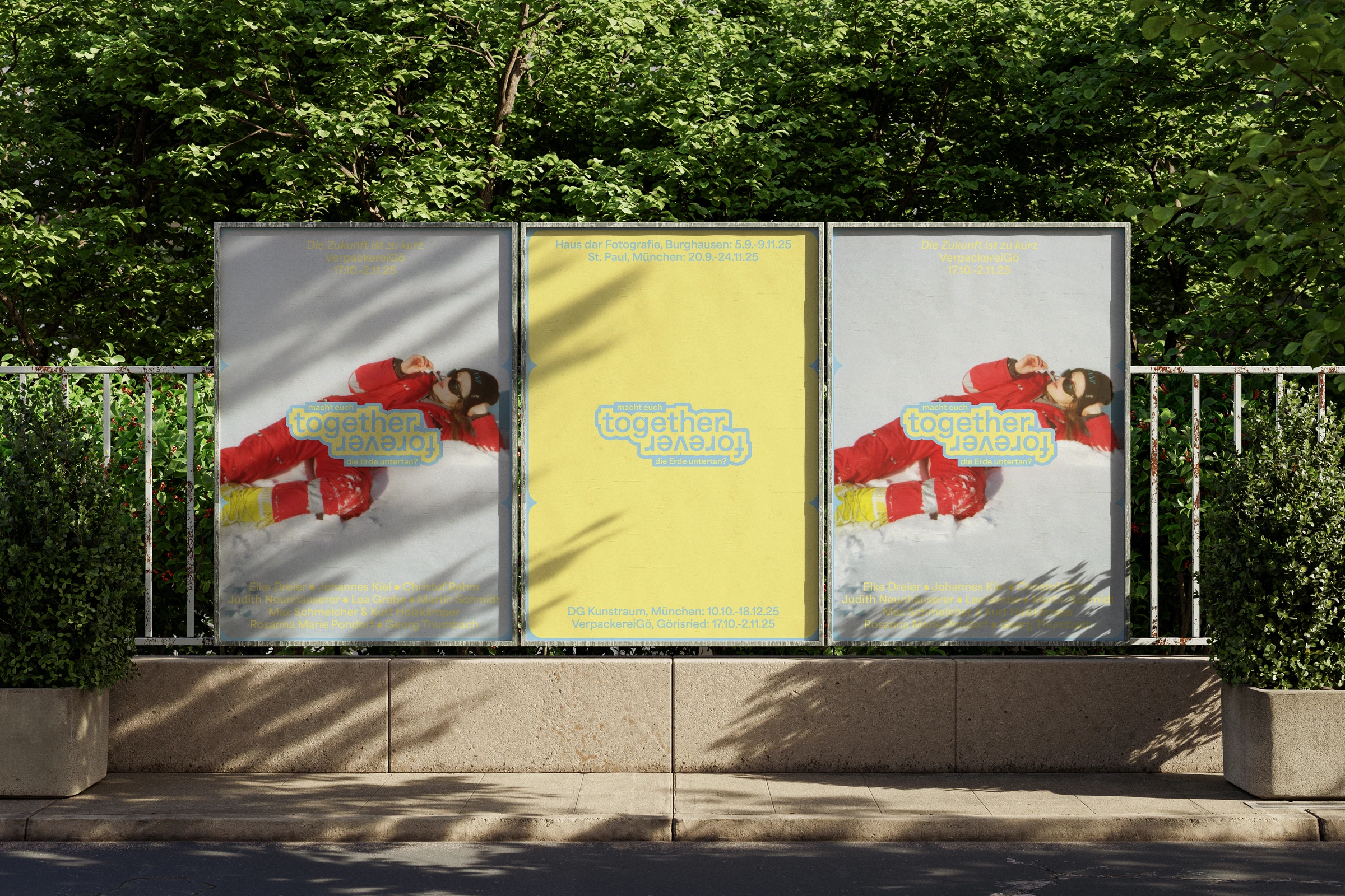 Three Together Forever posters on billboards beside a park fence
