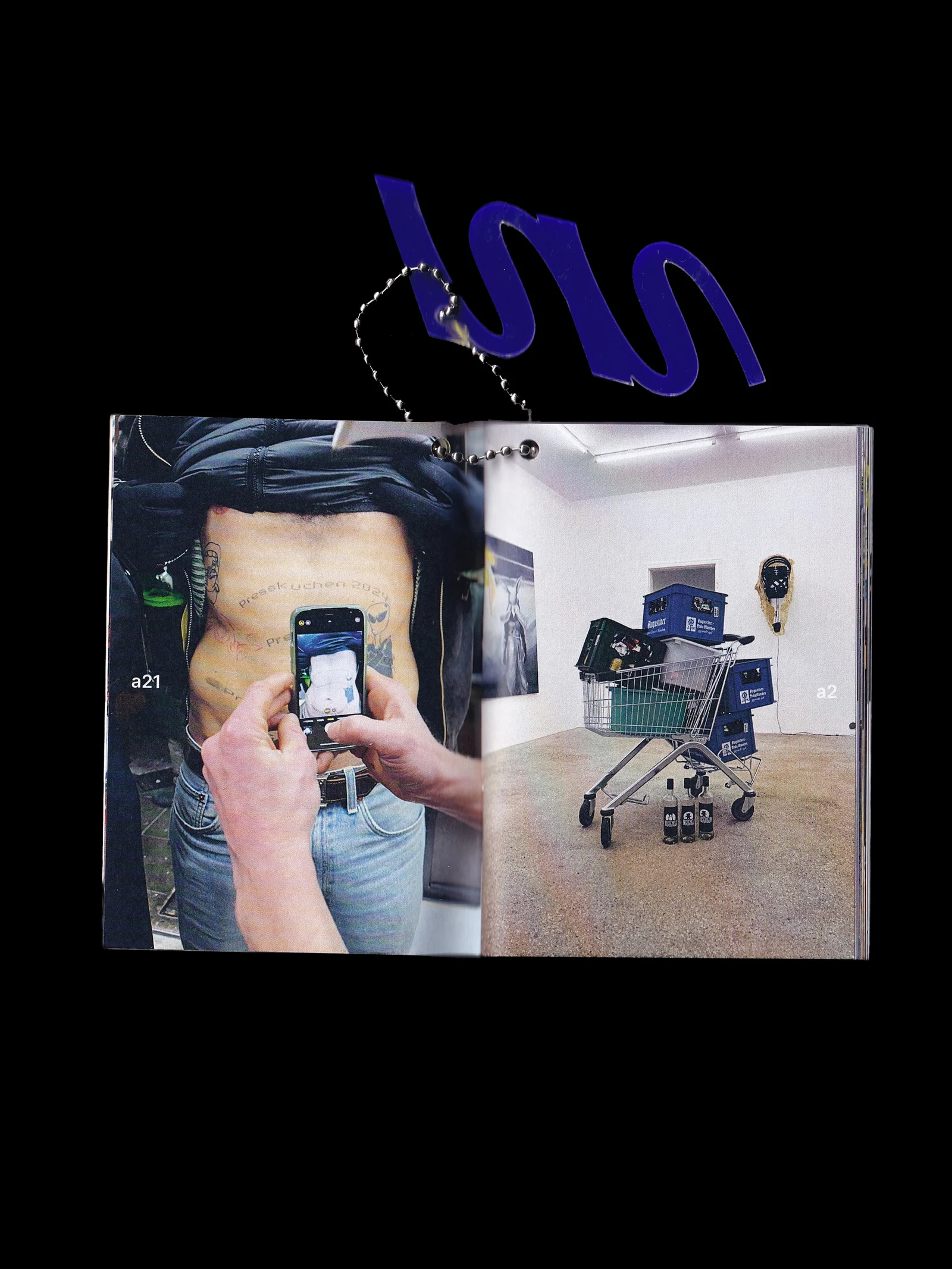Open making-of booklet with photos of the exhibition setup