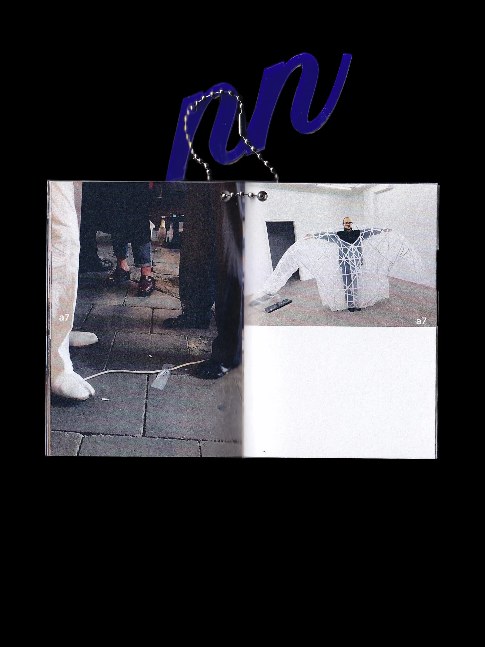 Open making-of booklet with photos of works in the gallery