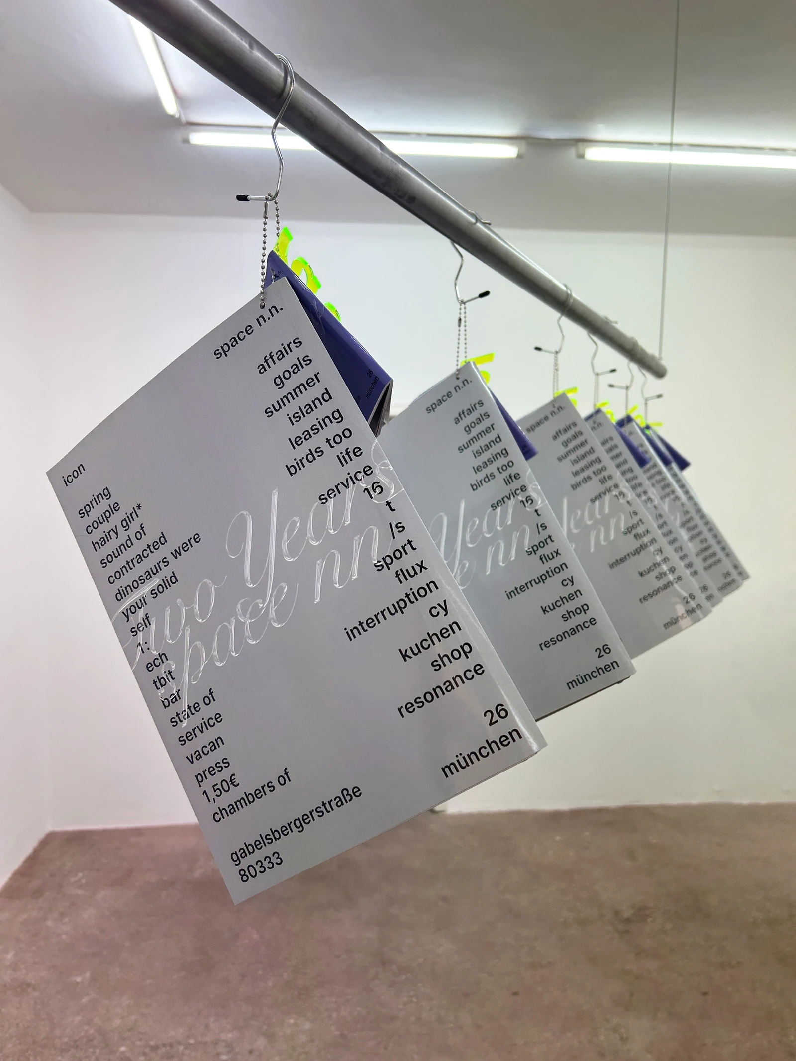 Hanging catalog with a calligraphic cover, seen at an angle