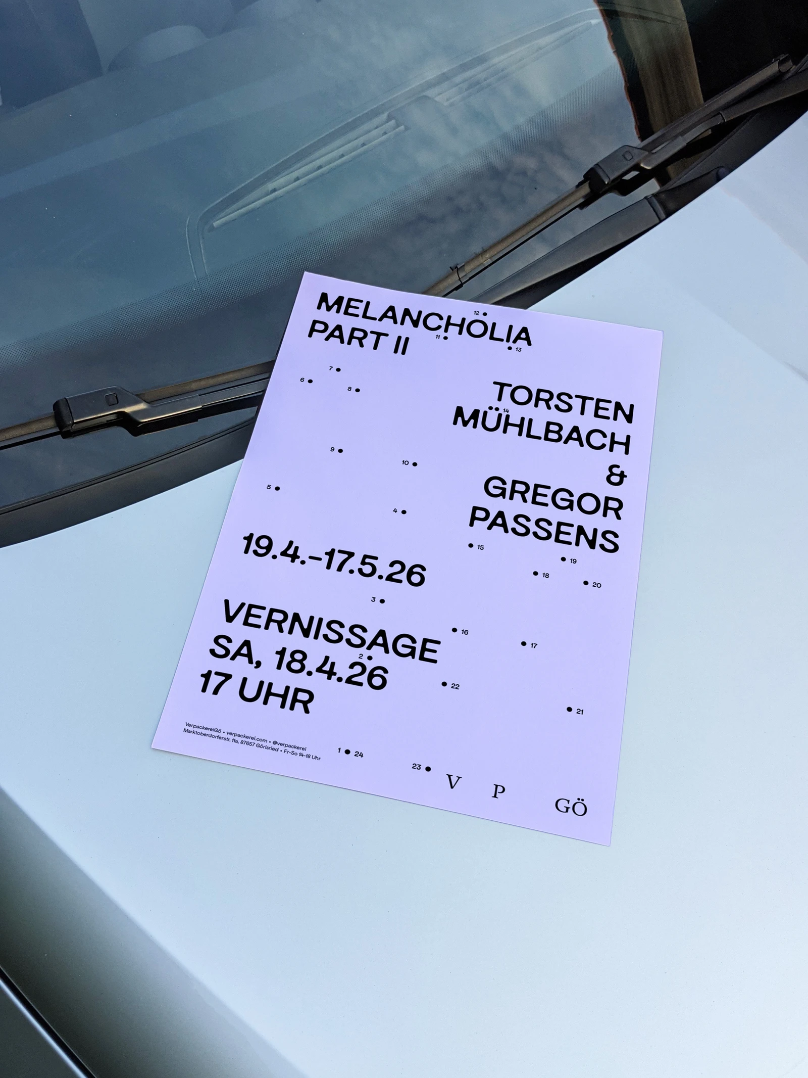 Melancholia Part II poster with numbered dots, lying on the hood of a car