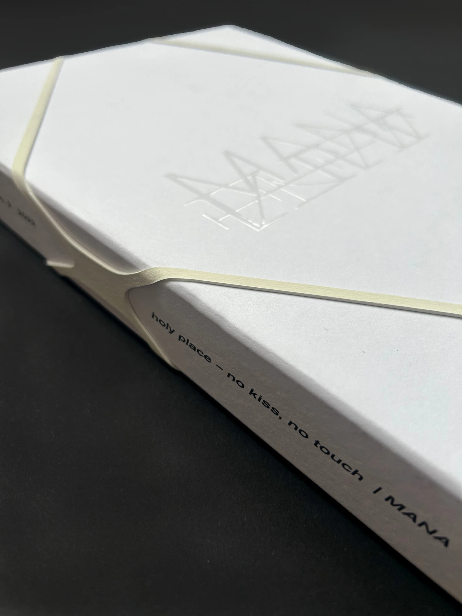 MANA catalog held closed by an elastic band