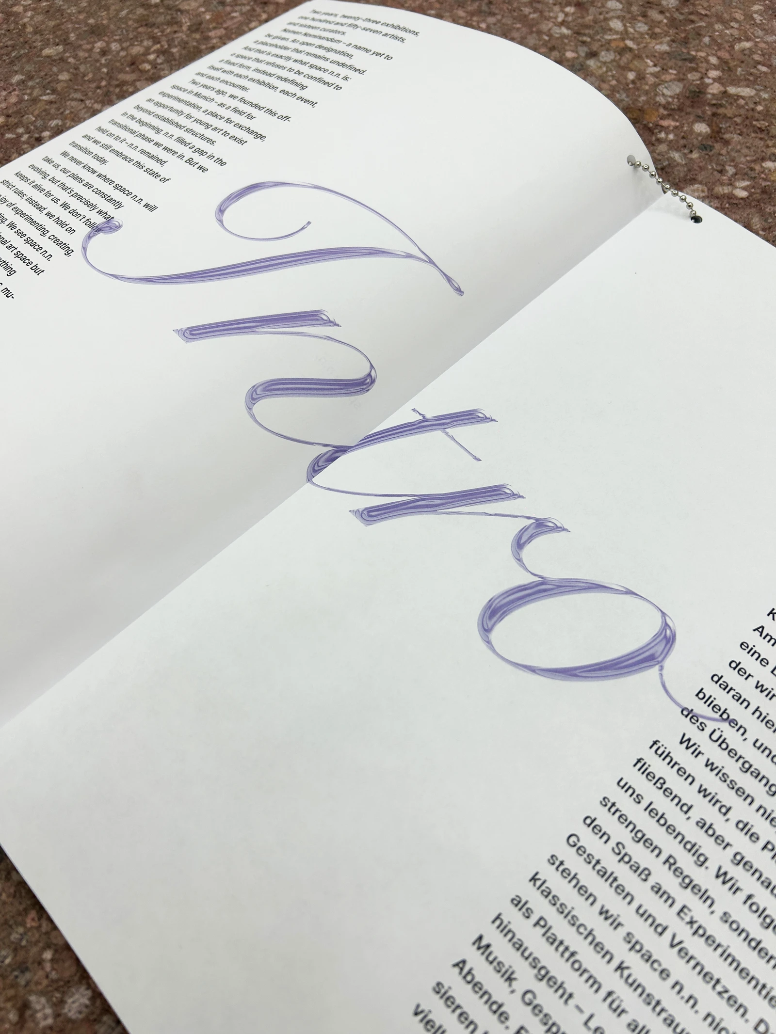 Catalog spread with a large calligraphic "Intro" over the text