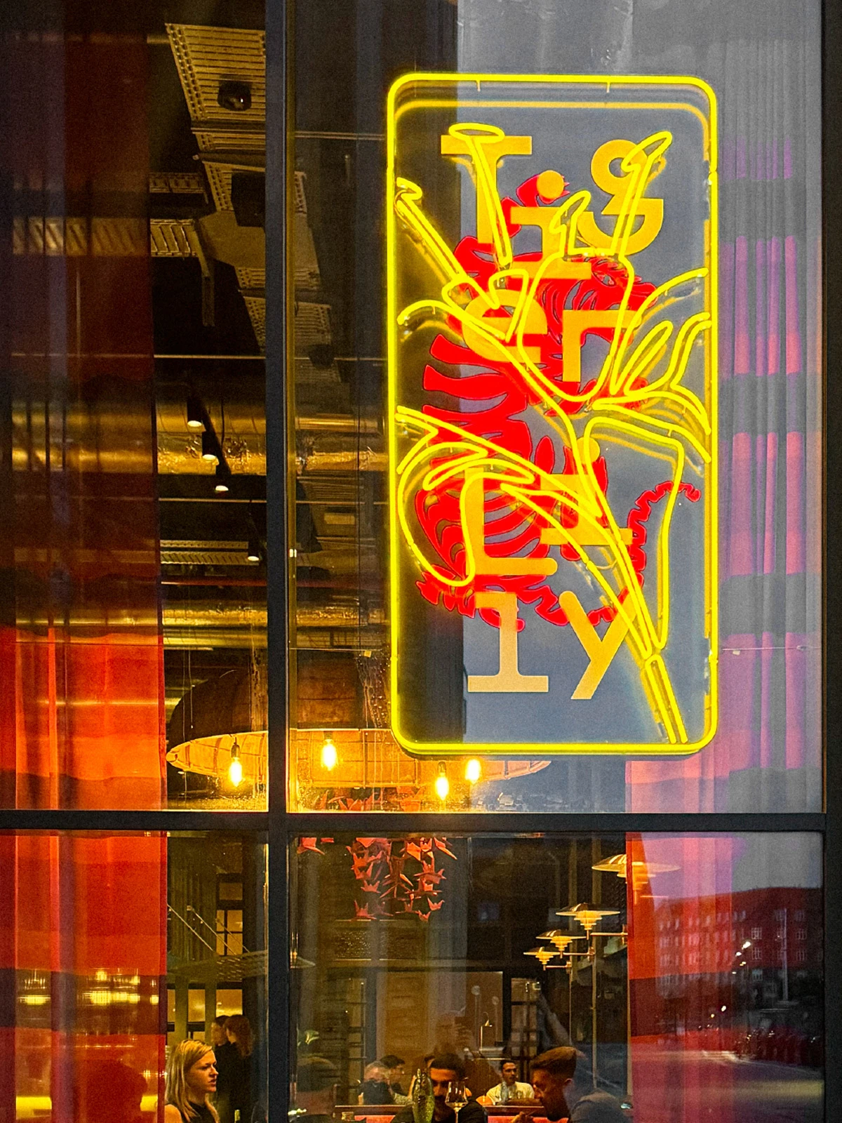 Neon sign with a red tiger and a yellow lily in a restaurant window