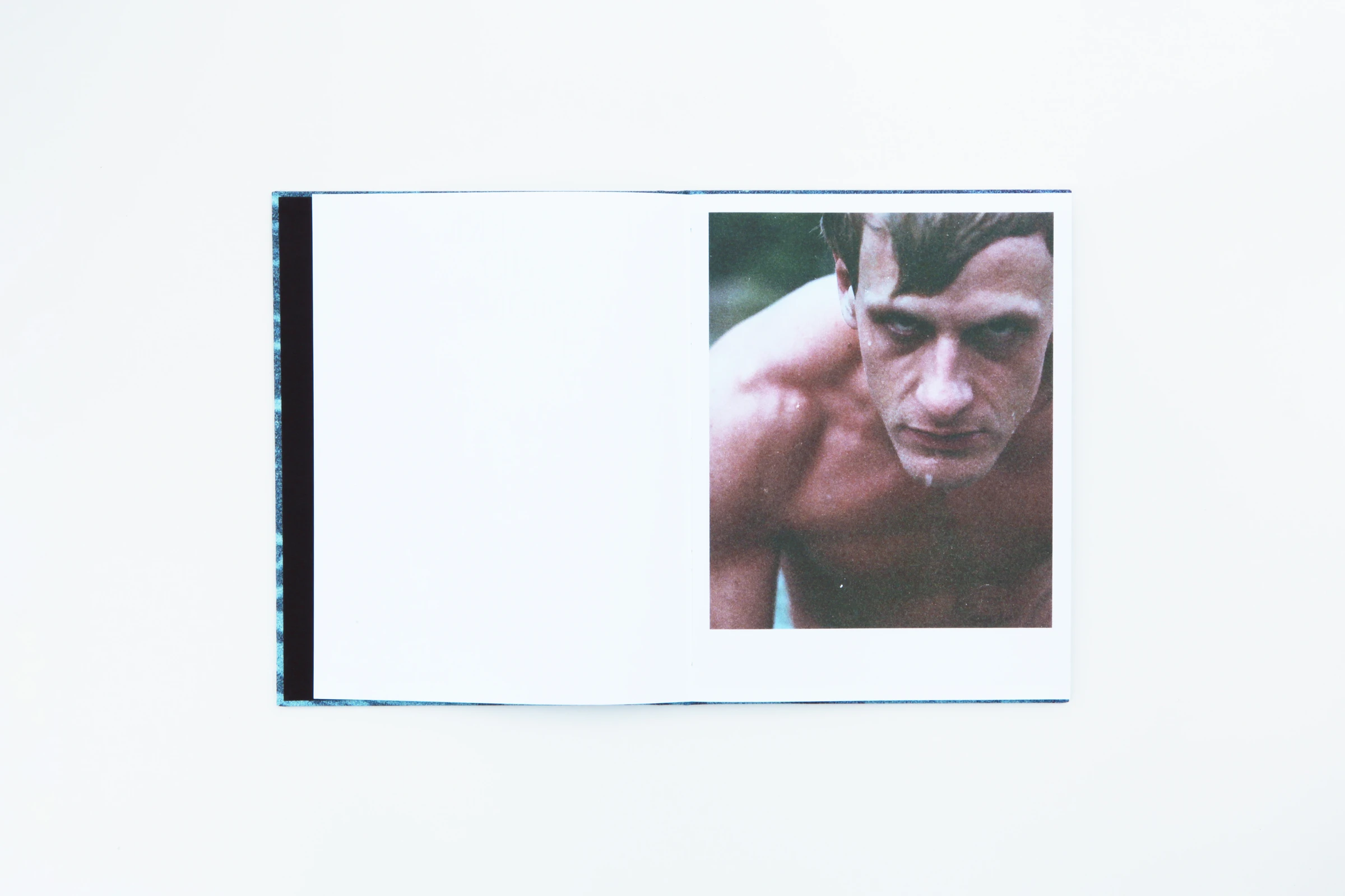 Open book with a portrait of a shirtless young man