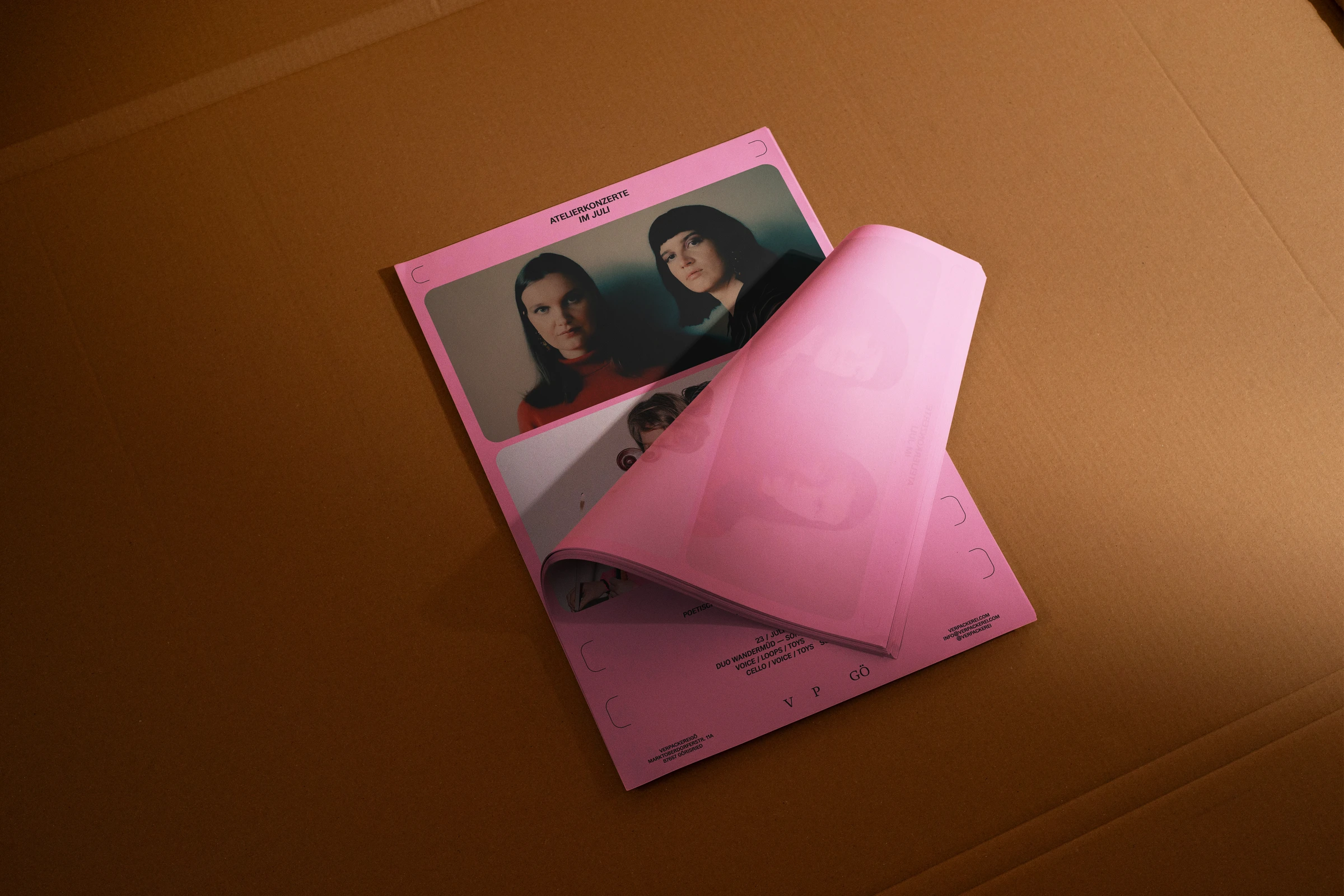 Pink Atelierkonzerte poster with a portrait of two musicians, one corner folded back