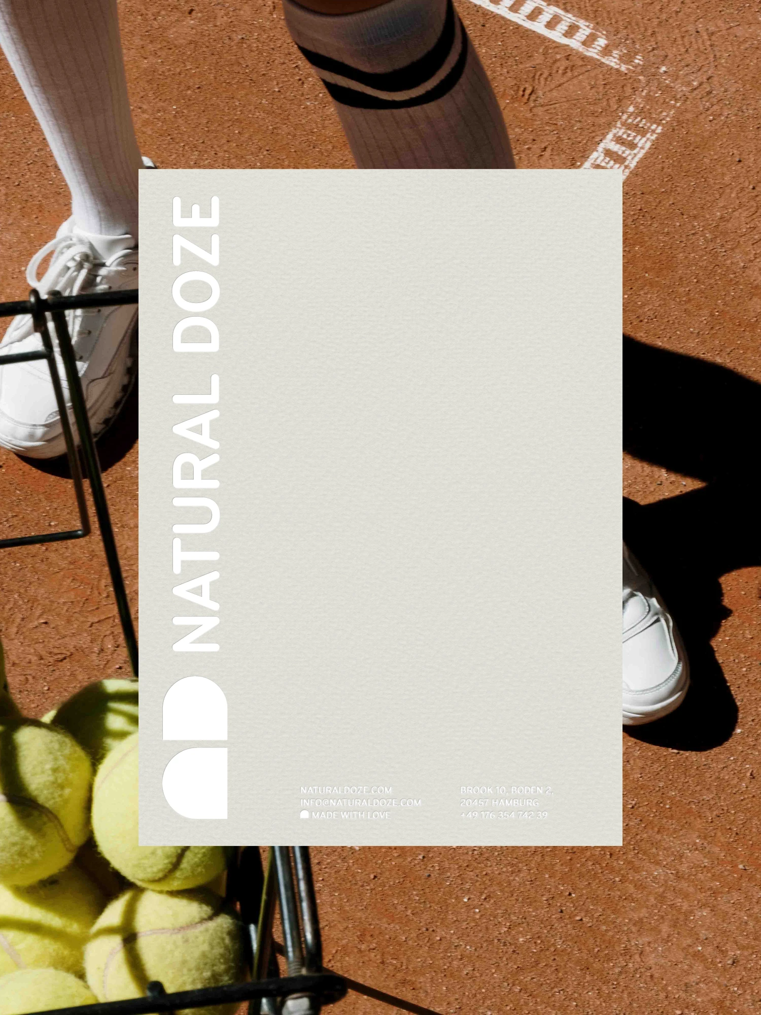 Natural Doze letterhead on a photo of a tennis court with a basket of balls