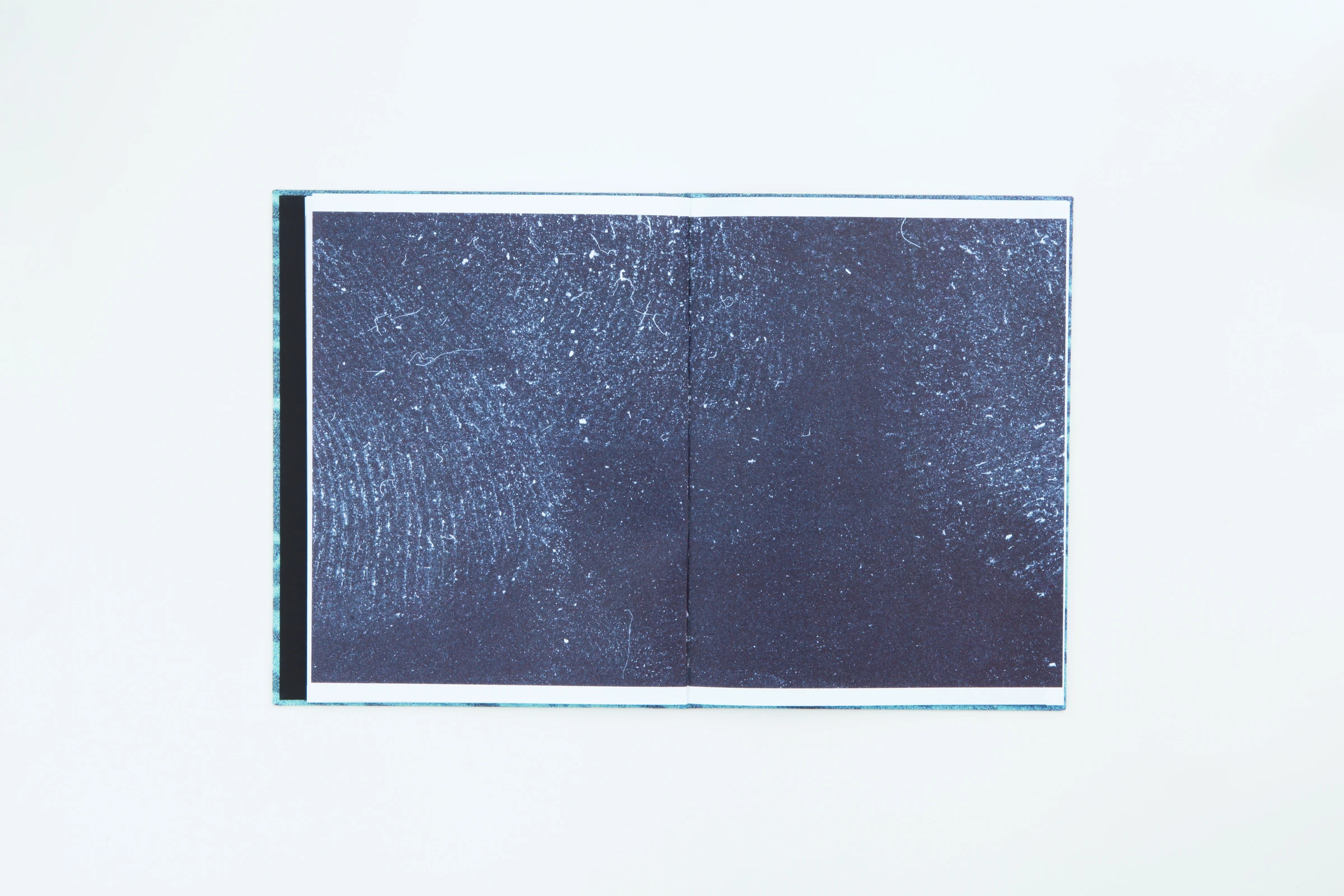 Open book with a dark blue image
