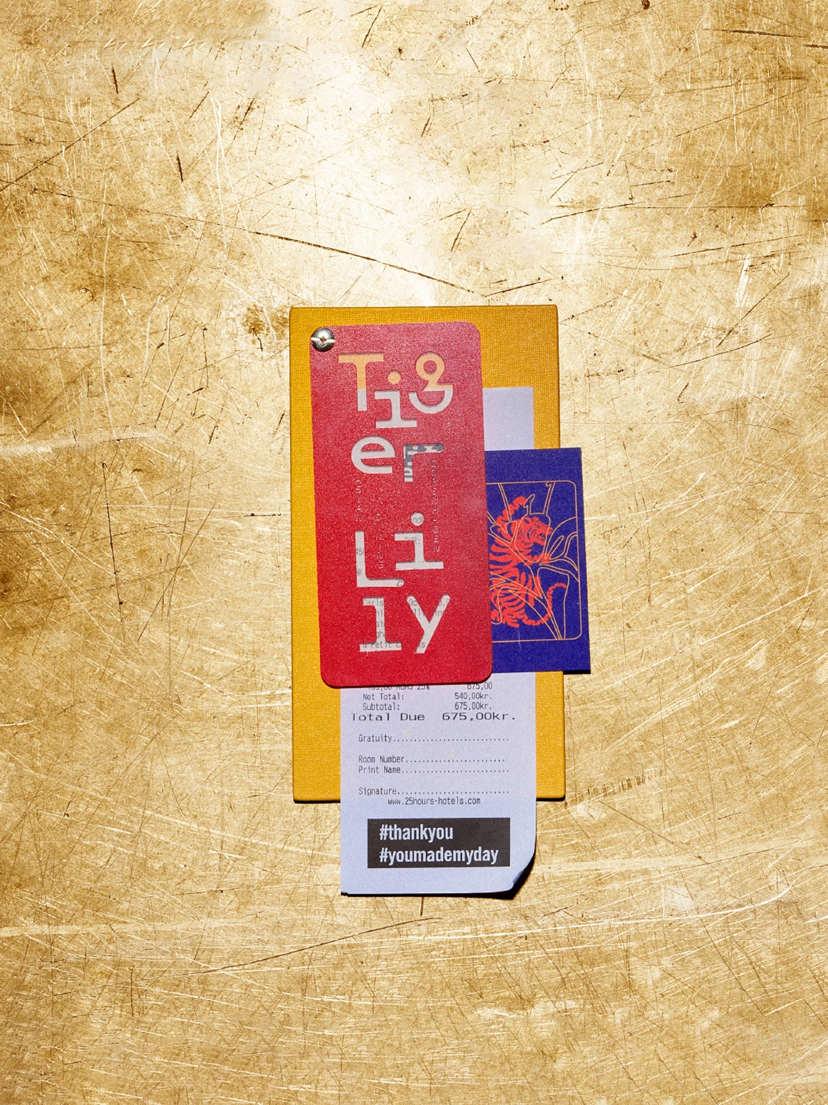 Tiger Lily bill folder with a receipt on a golden surface