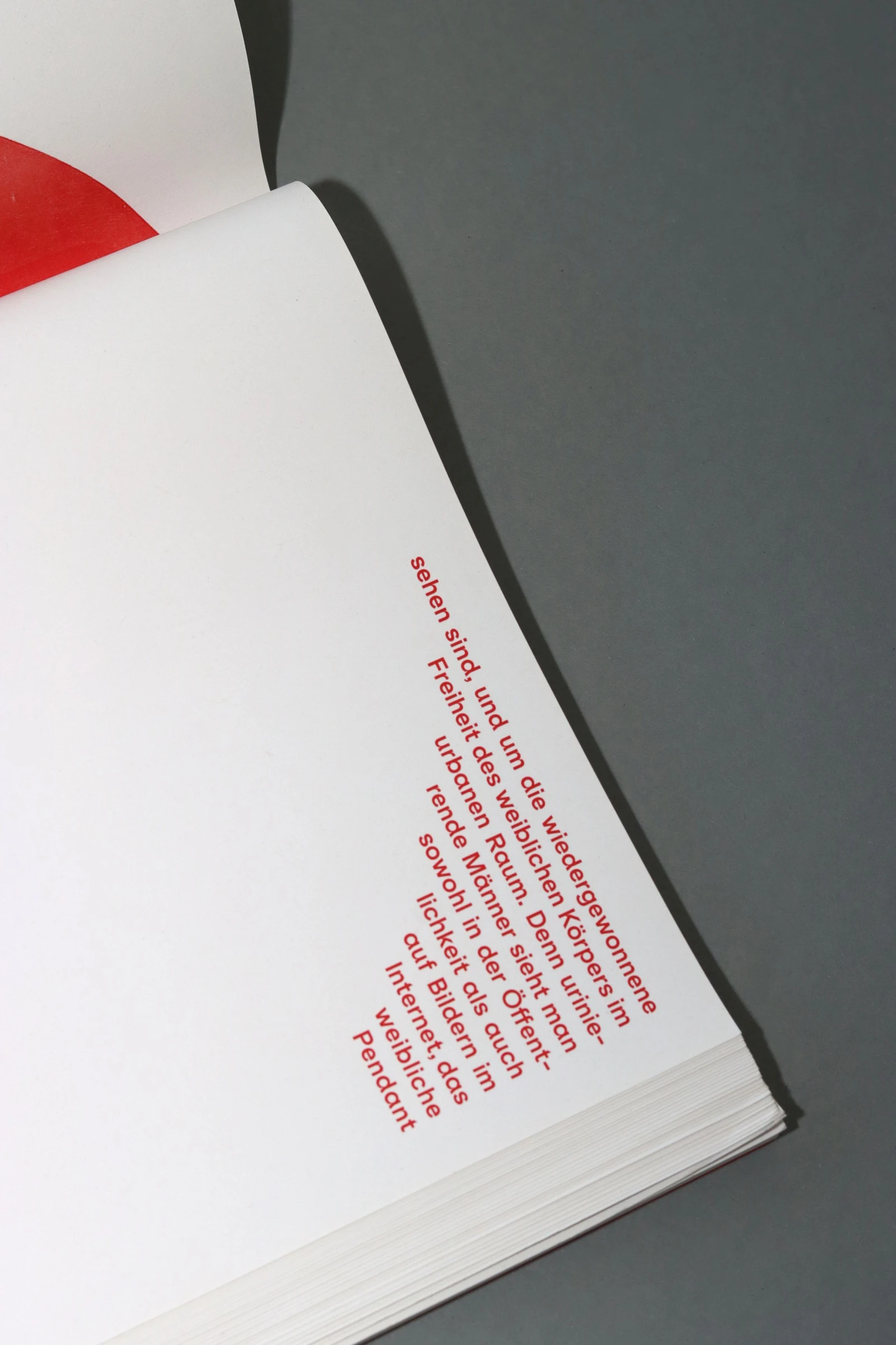 Book page with red text set along a curve