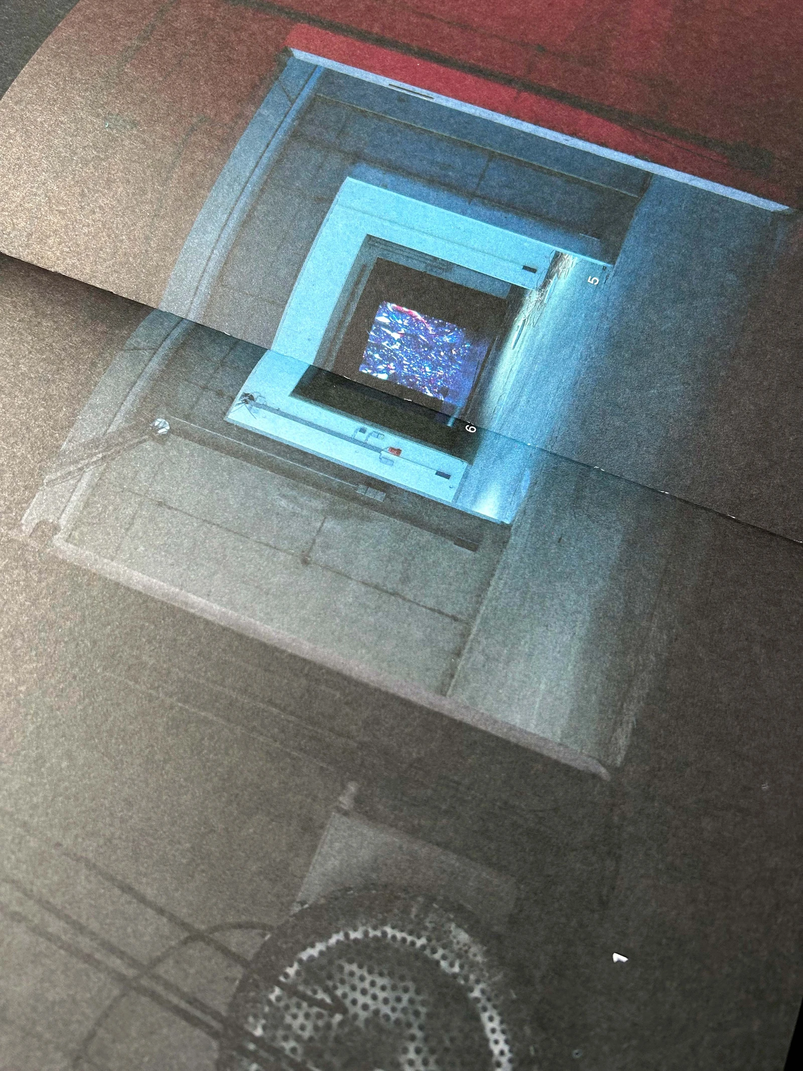 Catalog page with a photo of a glowing blue installation