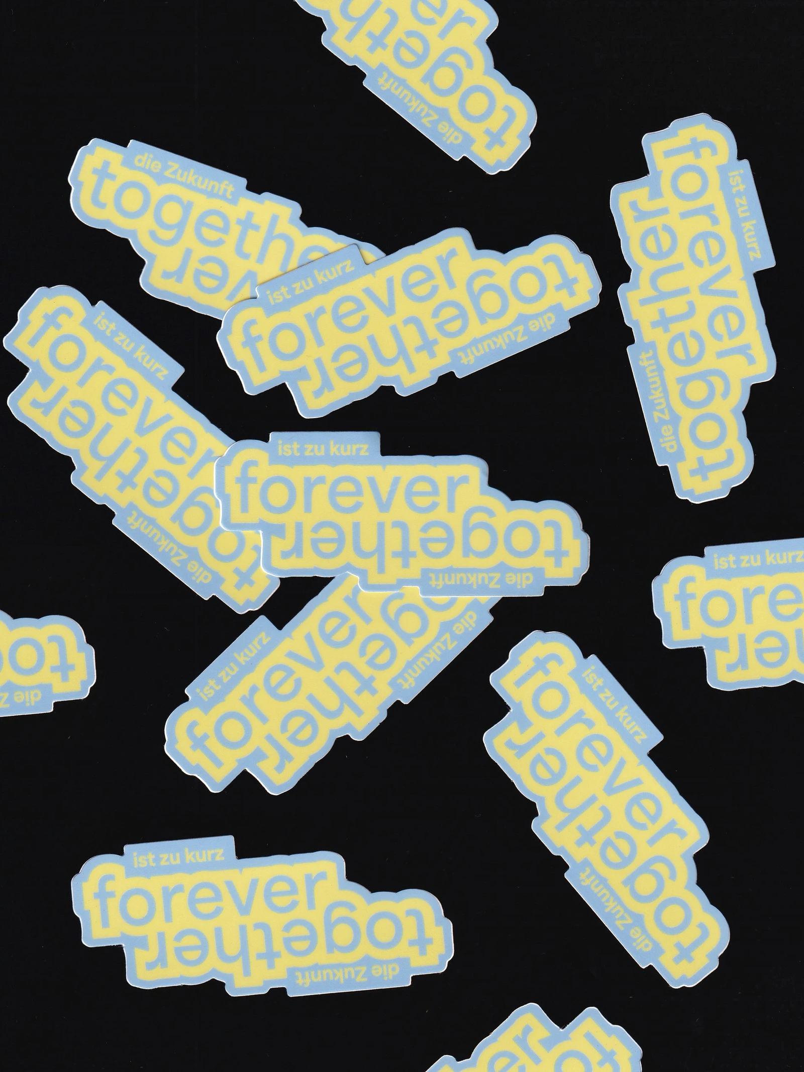Together Forever stickers scattered on black