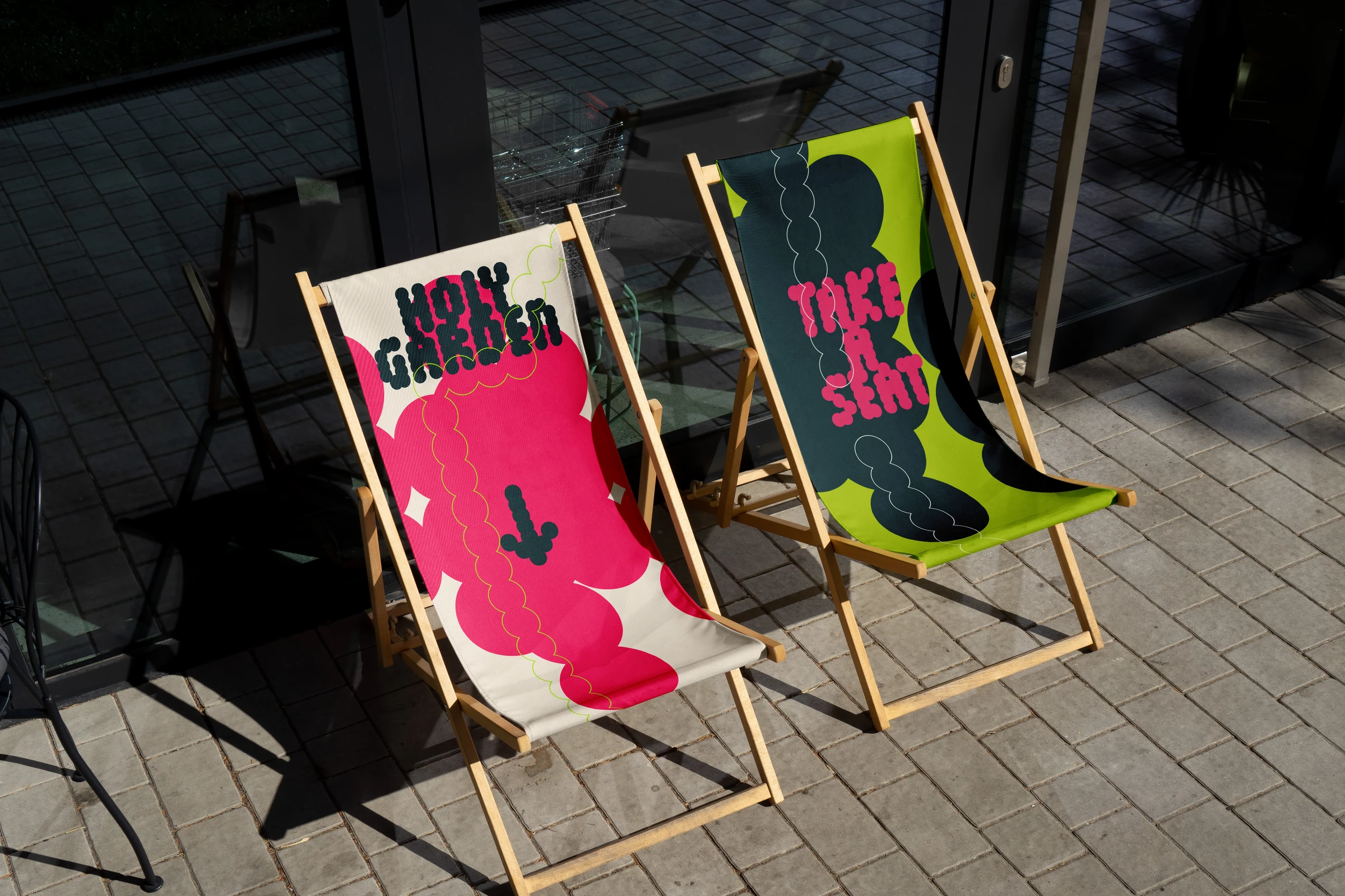 Two deck chairs printed with Holy Garden graphics