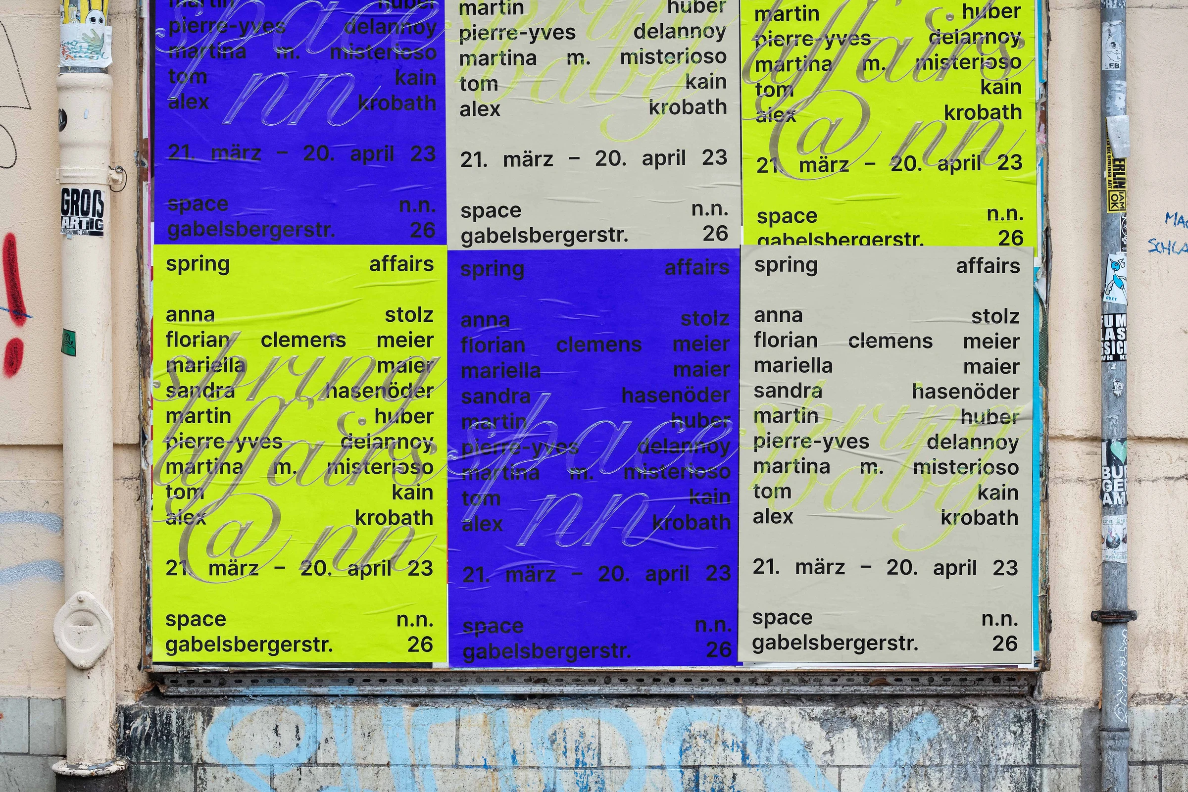 space n.n. exhibition posters pasted on a wall