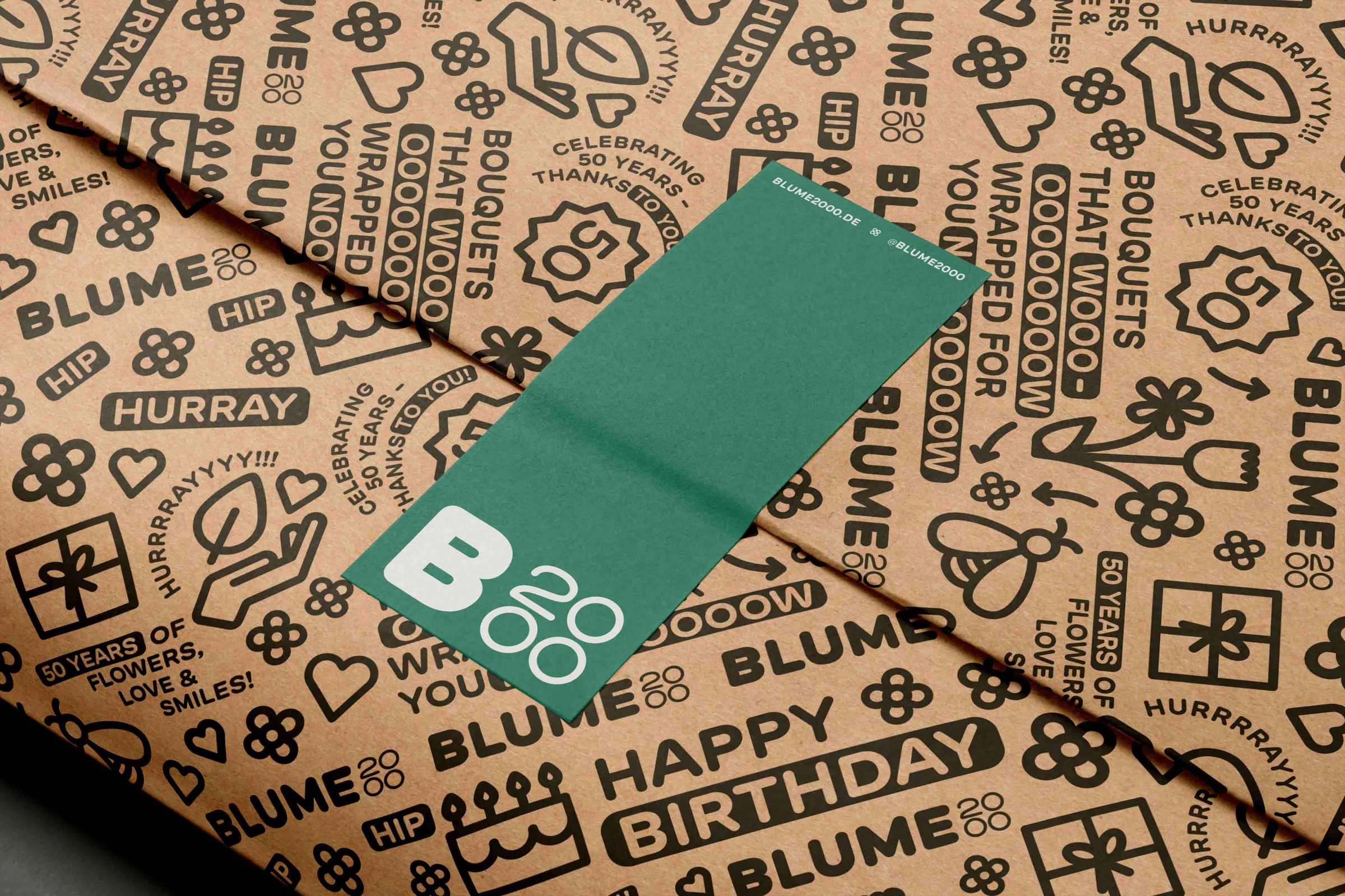 Kraft wrapping paper with the Blume2000 pattern and a green sticker
